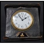 An early 20th century / Victorian travelling leather cased pocket watch clock having a white