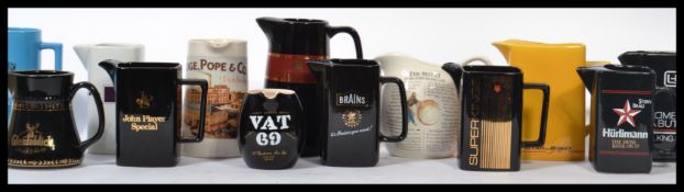 A collection of advertising point of  sale water / whisky jugs to include Alouette, Macallan, Vat