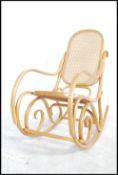 A vintage 20th century Thonet style light  bentwood rocker / rocking chair with bergere /  rattan