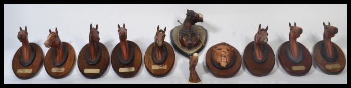 A large collection of Beswick horse wall plaques along with a Beswick lion wall plaque. Includes