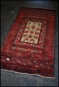 A stunning Persian woolen rug having central beige ground with tree of life motif, red ground