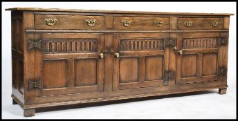 An exceptional Ipswich oak Jacobean revival dresser base sideboard having carved doors cupboards