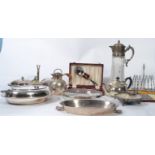 A collection of silver plate items to include a cut glass claret jug, silver plated twin handled