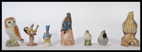 A group of Beswick and W. Goebel ceramic figurines of birds to include Thrush , Blue Tits , Barn Owl