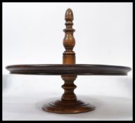 A Victorian mahogany circular table top cake stand with turned base and column having singular