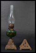 A 19th century Victorian cast metal oil lamp having a green glass reservoir. Along with another