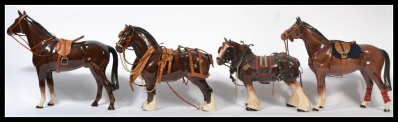 A group of five Beswick and other large ceramic horses to include a Beswick white braided shire