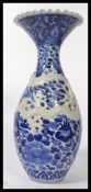 A late 19th / early 20th century blue and white ceramic Japanese baluster fluted vase with ribbed