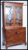 A 19th century Georgian bookcase on chest of drawers. Raised on bracket feet with a chest of drawers