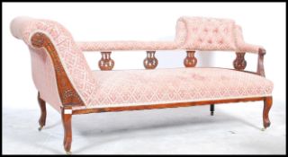 An Edwardian chaise longue / day bed being raised on cabriole legs with overstuffed seat, scrolled