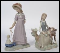 Lladro - A Lladro figurine entitled "Girl with Calf" # 01004813, marked to the base "Lladro hand