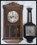 A vintage 20th century oak cased wall clock together with a oak aneroid barometer
