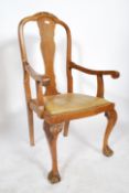 An early 20th century circa 1920's oak elbow - desk armchair / chair having a  leather drop in