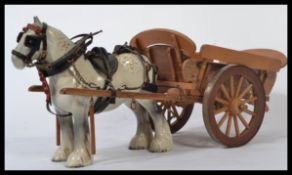A Beswick ceramic figurine of a shire horse and cart in a white and grey dappled colourway with