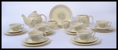 A vintage 20th century Susie Cooper Dresden Spray tea service in cream consisting of a teapot ,