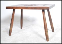 A 20th century carved oak side table with Celtic knot design raised on tapering legg by Ben Setter