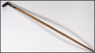 A 19th century Victorian sharks vertebrae walking cane, rosewood handle with inset ivory panel.