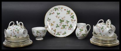 A vintage Wedgwood Wild Strawberry pattern tea service consisting of cups , saucers , side