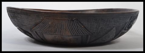 An early 20th century carved African tribal art bowl depicting scenes of figures people ,
