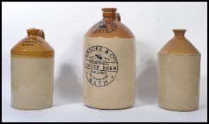 A collection of three vintage 20th century stone ware advertising flagons, to include Brooke and