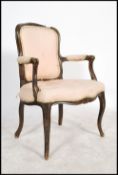 A 20th century French fauteil armchair of ebonised beech wood form. The reeded show wood frame