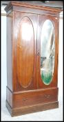 An early 20th century Edwardian inlaid mahogany double wardrobe with two fitted doors one of which