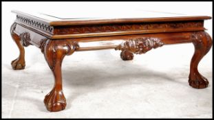 A good quality 20th century large mahogany Chippendale revival glass coffee table of square form