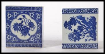 Two early 20th century Chinese Blue and White ceramic pillows, one decorated with temple dogs and
