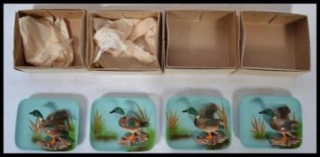 A set of four retro plaster wall wall plaques in the form of flying mallard ducks, each retaining