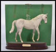 A Royal Doulton, "Desert Orchid" horse figure, DA184, on oval wooden plinth, complete in original