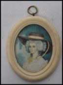 An 18th century portrait miniature painting on ivory of a lady in traditional dress and hat set to