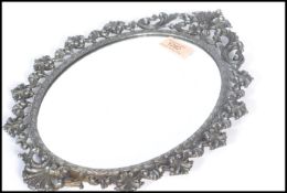 An early 20th century oval wall mirror having a si