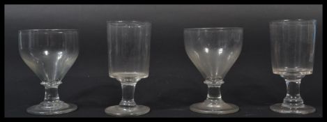 A pair of 19th century rummer / wine glasses having cylindrical bowls with terraced base together