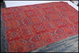 A large Oriental Shiraz style carpet - rug having red ground with multiple medallions with geometric