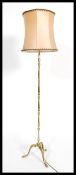 A good quality 20th century brass standard lamp being raised on spalyed legs with pad feet having
