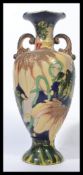 A 20th century Continental twin handled vase being tube line decorated with flowers and leaves. In