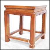 A 20th century Chinese opium stool / side  table in elm wood. The stool / side table raised on