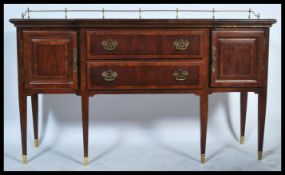 A good quality French empire revival mahogany inlaid breakfront sideboard being raised on square