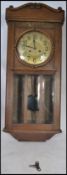 A vintage early 20th century oak wall clock having