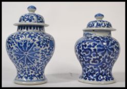 2 19th century Chinese blue and white ginger jars. Each with similar geometric designs and floral