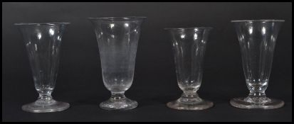 A group of four 19th century hand made wine glasses / cordial glasses with conical and trumped bowls