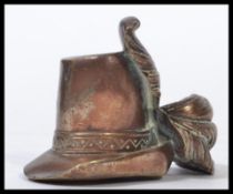A bronze paperweight in the form of a 17th century Capotain hat with feather. Measures 6.5 cm high