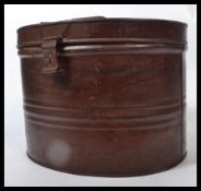 A 19th century Victorian tin hat box having a hinged lock to front with wood grain effect Handle