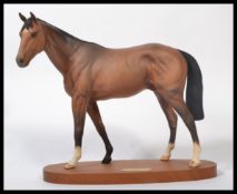 A Royal Doulton Racehorse `Troy`, model No. DA37 (Beswick No. 2674), bay matt, 29.8cm high on wood