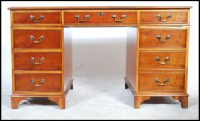 An antique Georgian style mahogany yew wood twin pedestal office desk having pedestals, each with