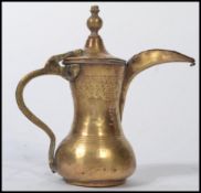 An 18th/19th century Persian / Islamic Arabic brass Dallah middle eastern coffee / tea pot having an