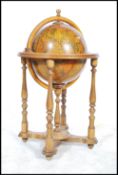 An antique style 20th century cocktail drinks cabinet in the form of a globe with hinged top section