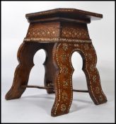 A good 19th century Islamic table of unusual form being profusely inlaid with bone decoration.