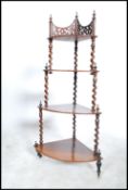 A Victorian Regency mahogany whatnot etargere of waterfall form being raised on turned legs with