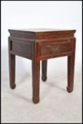 A 20th century Chinese opium stool / occasional in elm wood having an lacquered finish. The